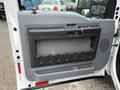 The image shows the interior door panel of a 2016 Ford F-550 Super Duty featuring a gray and black color scheme with a handle and storage compartment