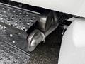 Close-up of the exhaust system of a 2011 Ford F-650 showing a metallic pipe and water droplets on the surface