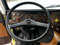 The interior view of a 1995 Freightliner FL086 showing the steering wheel dashboard gauges and control panel