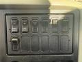 Control panel with multiple switches labeled for functions like park regen, inhibit regen, and beacon light