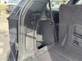 Interior view of a 2015 Dodge Durango cargo area showing storage compartments and black upholstery
