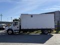 A 2011 Freightliner M2 106 truck with a white cargo box and a side door parked on a pavement. The truck has a non-descript design with clear body panels and minimal visible markings