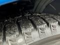 Close-up of a tire tread on a 2021 Kia Forte showing intricate patterns and debris on the surface