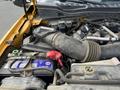 A close-up view of the engine compartment of a 2017 Ford F-250 SD showing the air intake and battery with visible dirt and wear