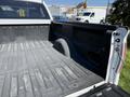 A 2014 Ford F-150 pickup truck with an empty, textured bed and a rounded wheel well visible on one side
