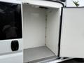 A 2020 RAM Promaster van with an open rear door revealing an empty cargo area with white walls and a smooth floor