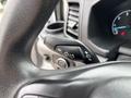 Close-up of a control lever in a 2020 Ford Transit 250 with various settings for turn signals and headlights