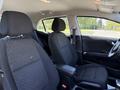 Interior of a 2018 Kia Rio5 featuring two black fabric front seats and a steering wheel, with a focus on the design and layout of the front cabin