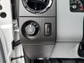 Dashboard controls of a 2013 Ford F-250 SD including the headlight switch and a button for additional features