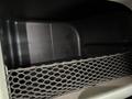 Interior storage compartment of a 2009 Peterbilt Highway featuring a black mesh netting for securing items