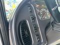 Interior controls of a 2019 Freightliner M2 106 including buttons for various functions and gauges displaying vehicle information