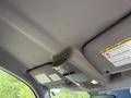 The ceiling interior of a 2019 Ford F-550 featuring overhead lights and warning labels