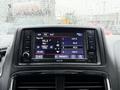 A digital display screen inside a 2020 Dodge Grand Caravan showing radio stations and satellite options