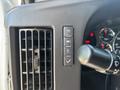 Close-up of the dashboard controls in a 2020 Chevrolet Express featuring buttons for lights air conditioning and a windshield wiper stalk