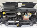 The engine compartment of a 2020 RAM Promaster showing the engine components air intake reservoir and fluid containers