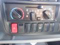 Dashboard control panel of a 2015 Hino 195 featuring climate control knobs and various function buttons