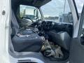 Interior of a 2019 Hino 195 truck showcasing the driver's seat dashboard and steering wheel with various controls and a seatbelt visible