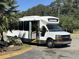 2017 Chevrolet Express with a white exterior and large front windshield features open side doors and a sleek design typically used for passenger transport