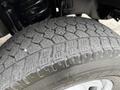 Close-up of a tire from a 2015 Ford F-350 SD showing a rugged tread pattern designed for durability and traction on various surfaces