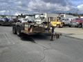 2013 JLG Industries Flat Deck Trailer with two axles and a hitch in the front for towing