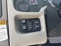 Control panel with various buttons for mirror adjustments, parking light activation, and panel lights on a 2012 International 7300 Workstar