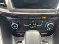 Interior dashboard controls of a 2019 Ford Transit Connect featuring air conditioning buttons and a passenger airbag indicator
