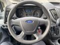 Steering wheel of a 2017 Ford Transit with the Ford logo visible and instrument panel displaying various gauges and indicators
