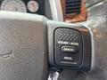 Close-up of a steering wheel control panel in a 2006 Dodge Ram 2500 showing buttons for resume accelerate cancel and decelerate
