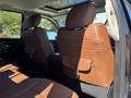 The interior of a 2015 RAM 1500 showing brown leather seats with headrests in the foreground