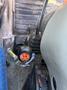 The gear shift lever of a 2010 New Holland T4050 tractor with an orange and black knob labeled A B B C