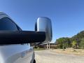 A close-up of the side mirror of a 2018 RAM 3500 showing its sleek design and chrome finish