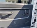 Interior door panel of a 2005 GMC C7500 Topkick featuring a door handle a power window switch and a textured surface