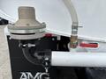 Close-up of a 2025 Peterbilt 536 pneumatic tank valve with a metal flange a clear hose connected and a red lever valve attached to a white pipe