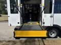 A 2020 Chevrolet Express with a lowered accessibility ramp extended from the rear doors for wheelchair access