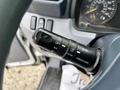 A close-up of a 2015 Mitsubishi Fuso FE160 control stalk showing various driving functions and settings including off set and resume