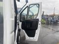 A 2023 RAM Promaster 3500 with its driver's side door open showcasing the interior door panel and handle