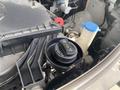 Close-up of the engine compartment of a 2024 Mercedes-Benz Sprinter featuring a coolant reservoir cap and other mechanical components