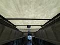 The interior ceiling of a 2018 Ford E-450 with a textured light panel and lines running across its length