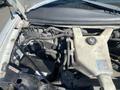 An open hood of a 2011 Chevrolet Express showcasing the engine components including the battery coolant reservoir and various hoses