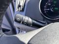 Close-up of a control stalk in a 2015 Hyundai Sonata for headlight settings featuring symbols for auto lights and turn signals
