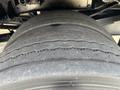 Close-up of a heavily worn tire from a 2013 RAM 5500 showing deep grooves and uneven tread wear