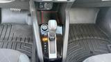 Interior view of a 2019 Nissan Kicks featuring the gear shift console with buttons for park reverse neutral and drive along with a push start button