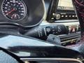 2024 Kia Forte5 dashboard with speedometer and control buttons for wipers and headlights