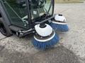 A 2019 Madvac LS175 street sweeper with two large rotating brushes at the front equipped with blue bristles