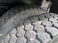 Close-up of the tread pattern on a tire of a 2011 International 4300 showing deep grooves and rough texture designed for traction