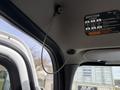 A close-up of the interior ceiling of a 2016 Freightliner 108SD showing a mounted cable and a indicator label for a 10-speed transmission