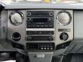 The interior dashboard of a 2012 Ford F-550 featuring various controls including radio knobs and buttons