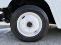 Close-up of a white wheel on a 2017 Freightliner MT45 featuring a five-bolt pattern and black tire with visible tread details