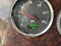 Close-up of a tachometer gauge from a 2013 Kenworth T370 displaying 4809.8 hours and a temperature of 24 degrees Celsius