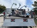 A 2016 RAM 5500 truck with a flatbed carrying an industrial machine secured with orange straps